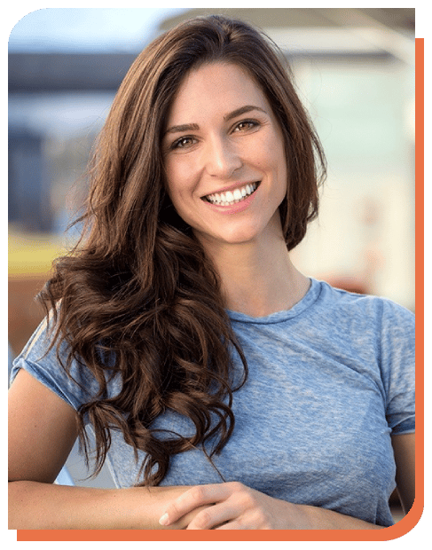 Smiling woman in blue shirt at dental practice in Puyallup, WA.