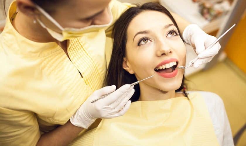Dentist examining patient's teeth during cosmetic dental consultation in Puyallup.