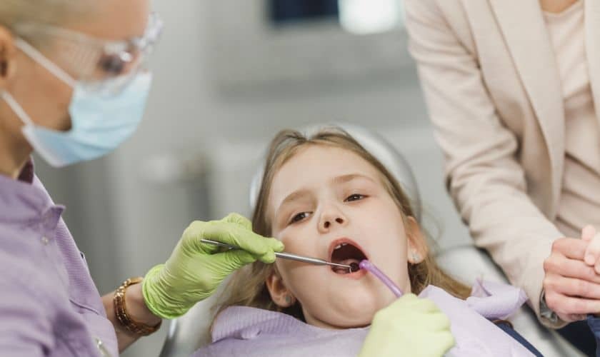 Young patient receiving oral examination from pediatric dentist in Puyallup dental office.