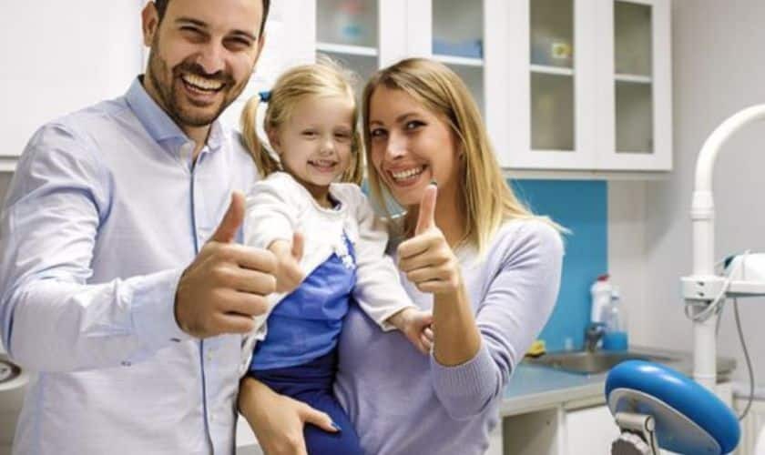 Happy family giving thumbs up at dental practice in Puyallup, WA.