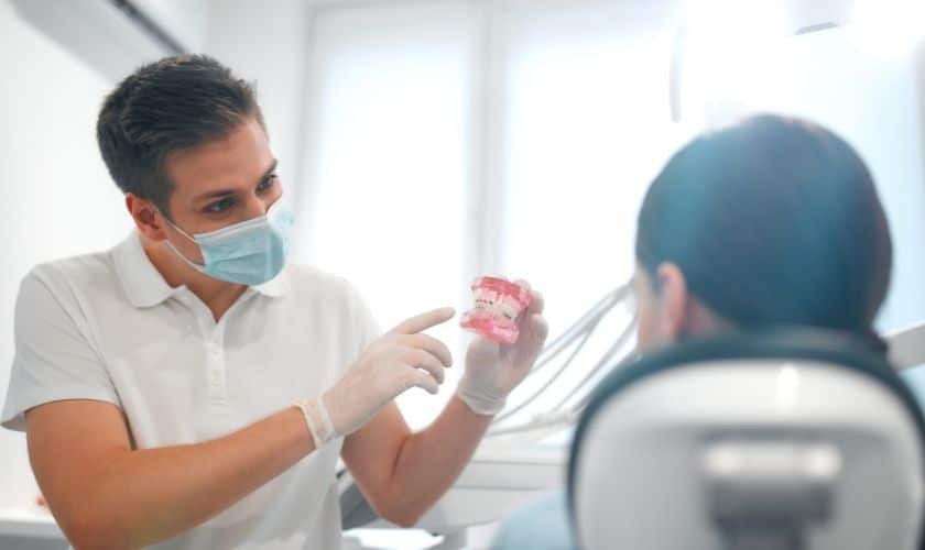 Dentist showing dental model to patient during consultation in Puyallup office.