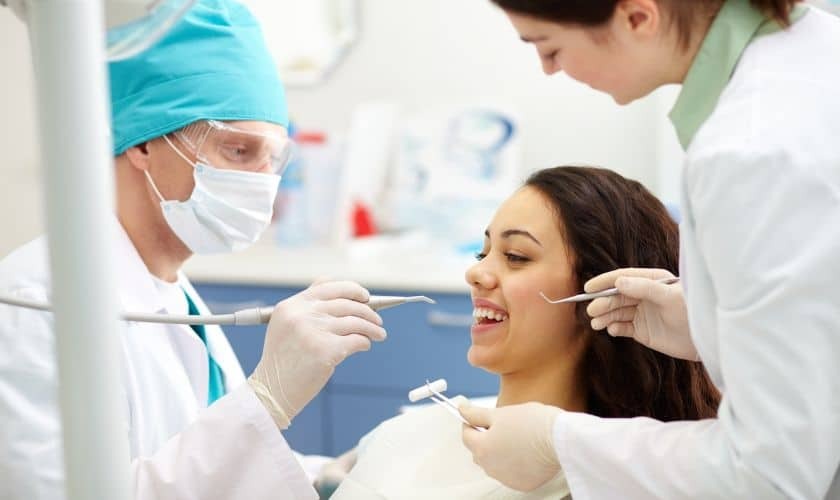 Dentist examining patient's teeth during professional dental exam in Puyallup clinic.
