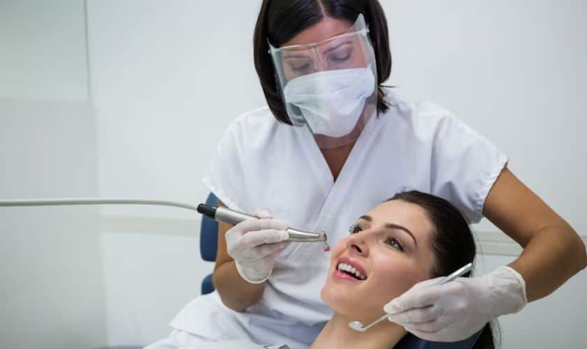 Cosmetic dentist examining patient's teeth during dental treatment in Puyallup.