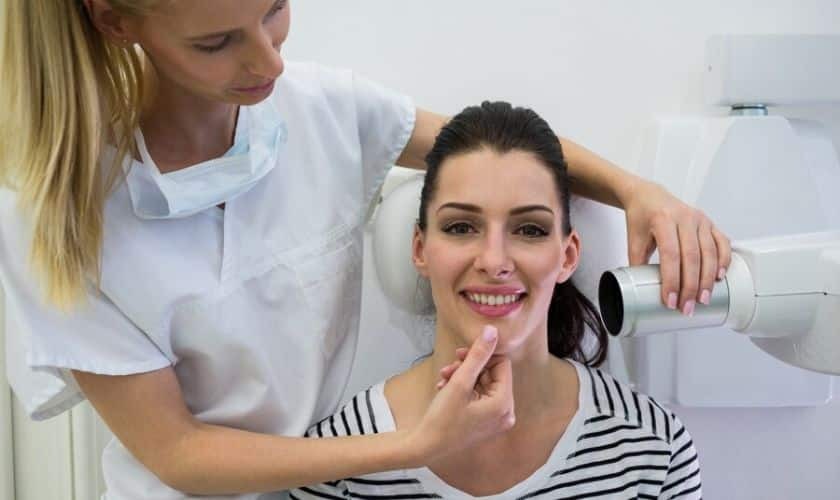 Dental hygienist examining patient's smile during oral health consultation at Puyallup practice.