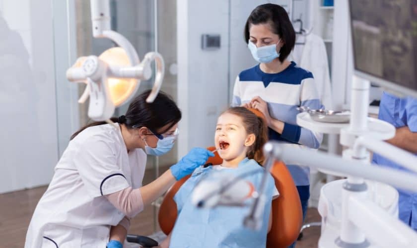 Young patient receiving dental examination from pediatric dentist in Puyallup office.