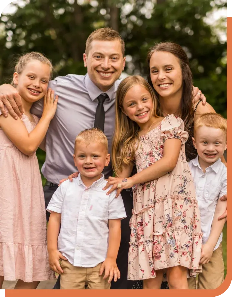 Dr. Stroyan smiles with his family of five children in Puyallup, Washington.